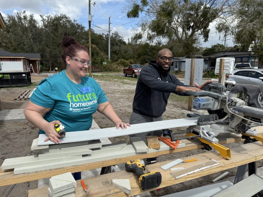 Priscilla on Job Site Working with Volunteer